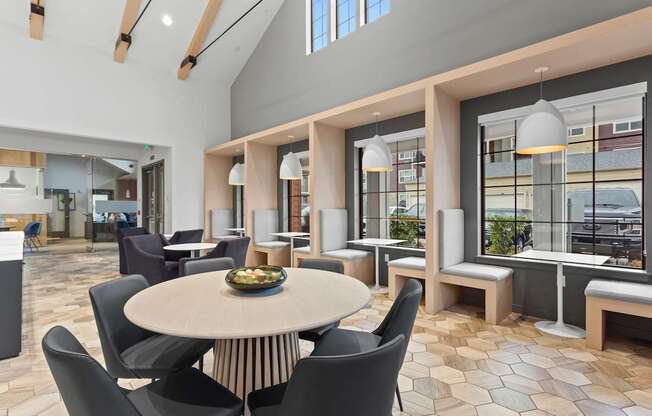 A modern dining area with a round table and chairs.