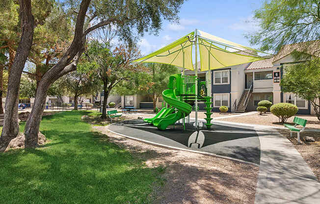 Community Playground with a Slide and Yellow Canopy at Monterra Apartments located in Las Vegas, NV.