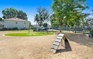 a park with a bench and a grassy area in front of a building at The Park Apartments, Rancho Cucamonga, California