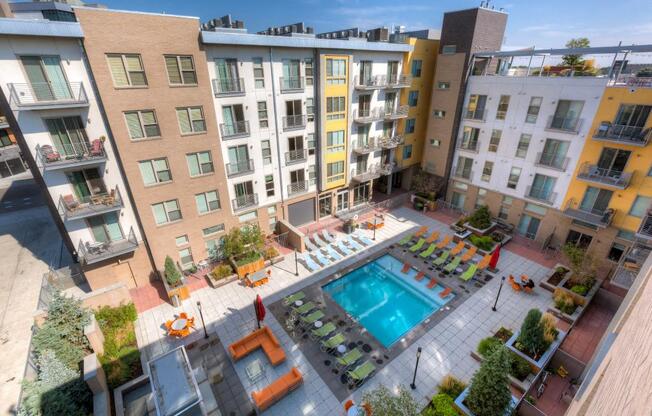 a rendering of an apartment building with a swimming pool