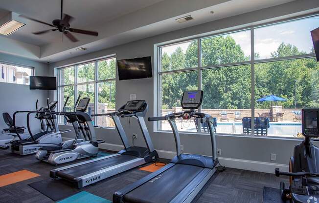 A gym with treadmills and exercise bikes.