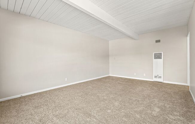 A room with a carpeted floor and a white ceiling.