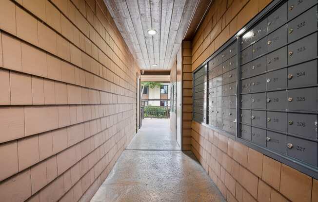 a long hallway with wooden walls and lockers with numbers on them