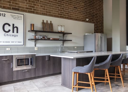 BBQ Area With Seating At Iroquois Club Apartments In Naperville, IL