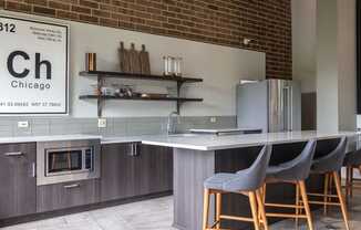 BBQ Area With Seating At Iroquois Club Apartments In Naperville, IL