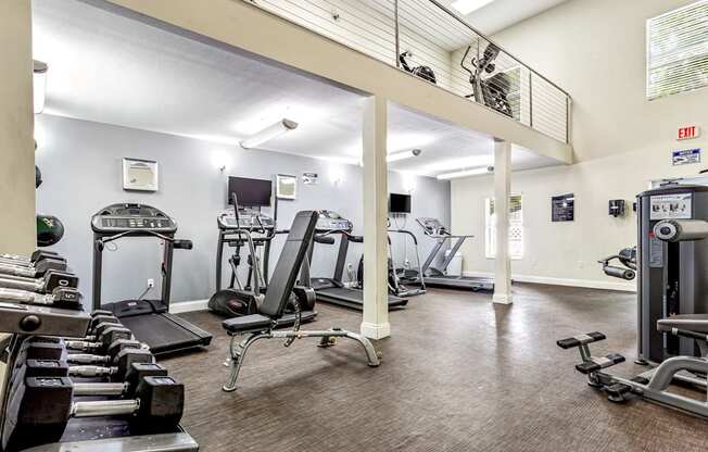 the gym has plenty of exercise equipment at the enclave at university heights apartments at Waterford Park Apartment Homes, LLC, Lauderhill