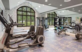 a gym with cardio equipment and a large window at Trails at Short Pump Apartments, Richmond, Virginia