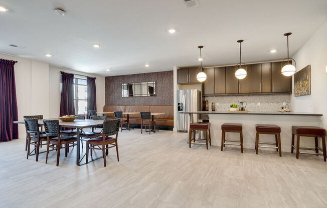 a dining room and kitchen with a table and chairs