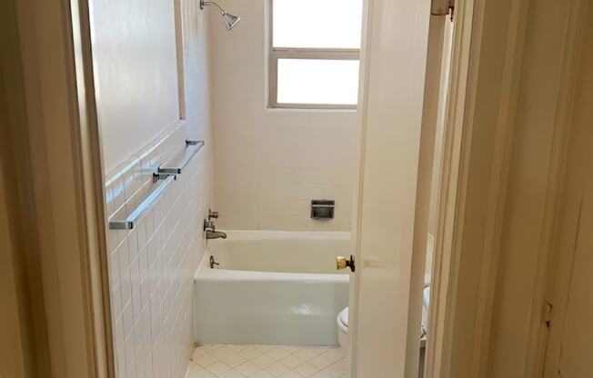 A white bathroom with a tub and shower.