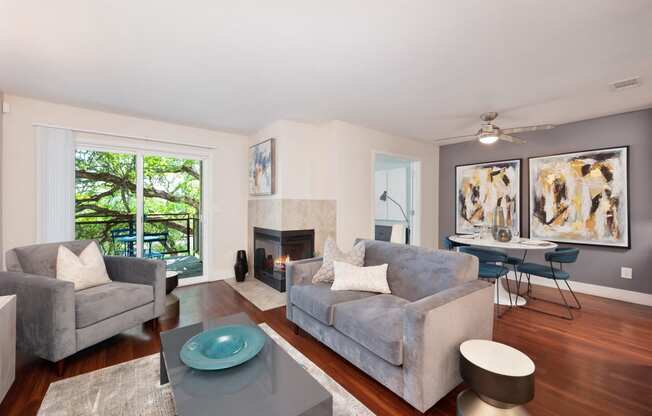 a living room with a fireplace and a couch at Folsom Ranch Apartments in California