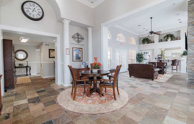 a dining room and living room with a table and chairs