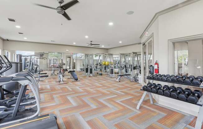 the generously sized gym is equipped with cardio machines and weights