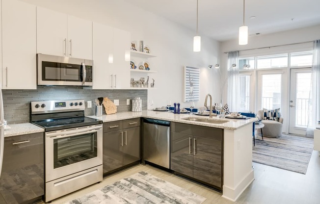 Kitchen attached to living room at Link Apartments® Grant Park, Atlanta, GA