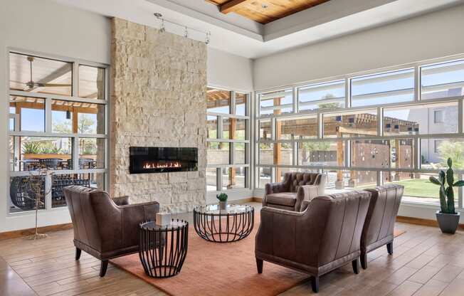 a living room filled with furniture and a large stone fireplace