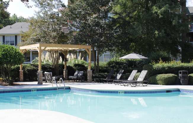 a swimming pool with chaise lounge chairs and a pergola at Stillwater at Grandview Cove