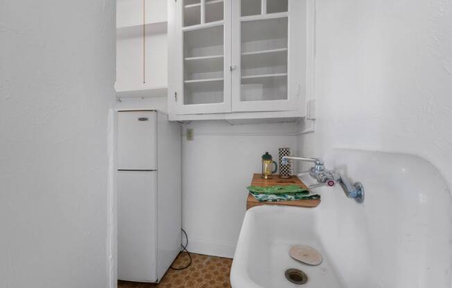 a small kitchen with a sink and a refrigerator