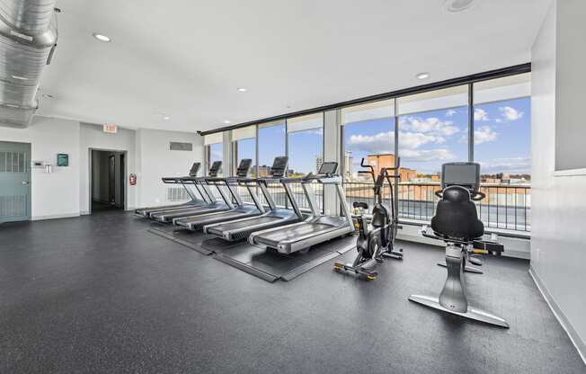 A gym with treadmills and exercise bikes.