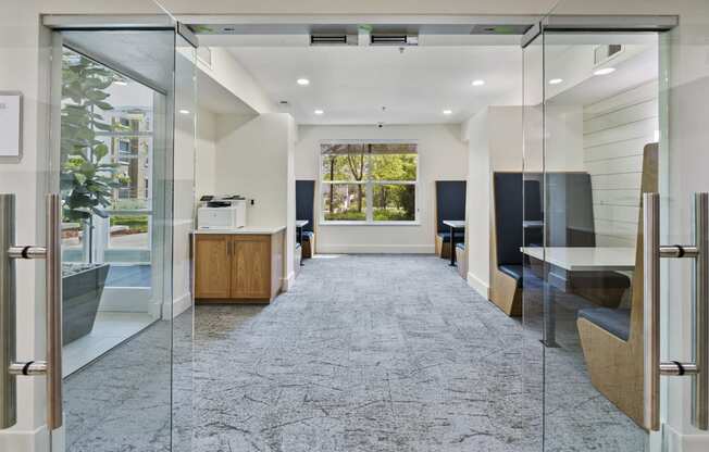 a room with glass doors and a table with a printer on it