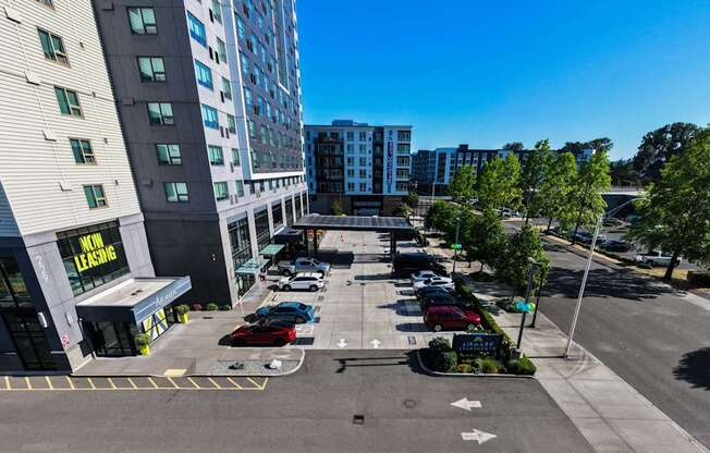A parking lot with cars and a building with a sign that says