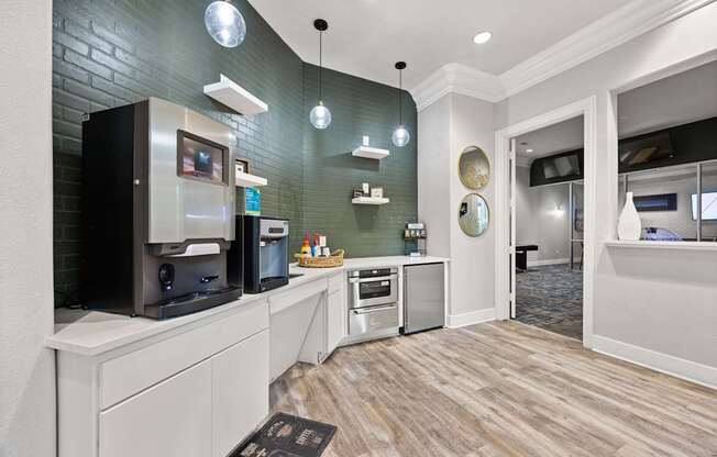 A kitchen with a refrigerator, oven, and microwave.
