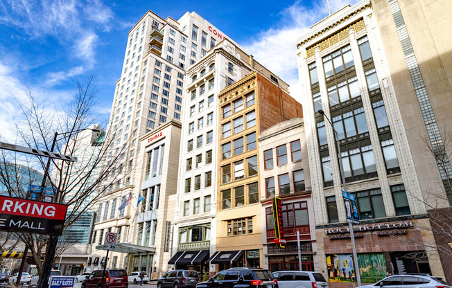 a city street with tall buildings and a blue sky in the background at 26 West, Managed by Buckingham Urban Living, Indianapolis