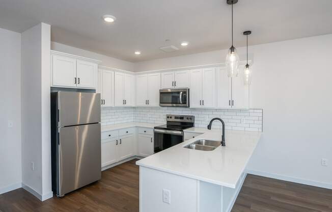 a renovated kitchen with white cabinets and stainless steel appliances at The Crossings at Windsong, Prescott Valley, AZ