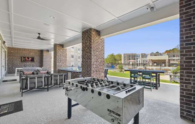 A Kettler outdoor grill is in the foreground of a patio area.