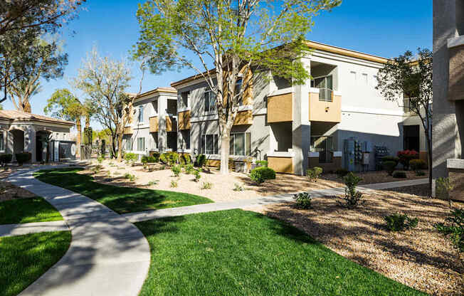 A row of modern houses with a pathway in the foreground.