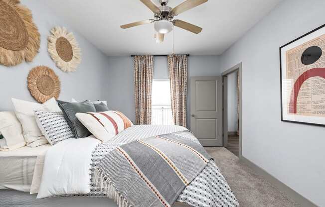 a bedroom with a bed and a ceiling fan