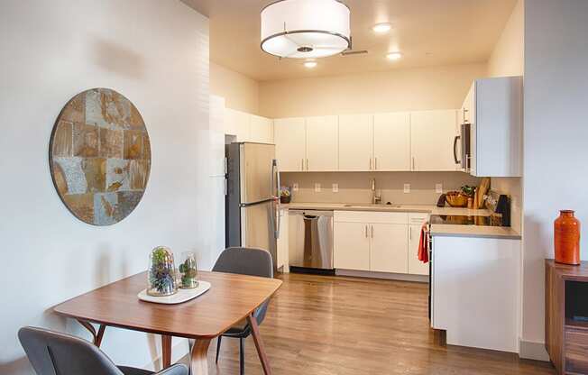 Kitchen with White Cabinets and Small Dining Table