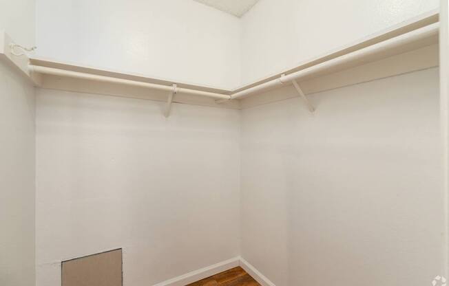 A white room with a wooden floor and a white ceiling.