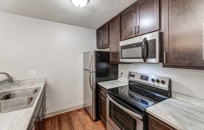 a kitchen with stainless steel appliances and wooden cabinets