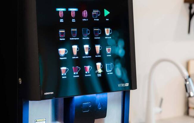 A black vending machine with a digital display and a variety of drink options.