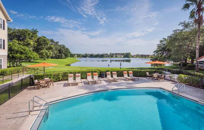 The Colony at Deerwood Apartments - Resort-style pool with beautiful lake views