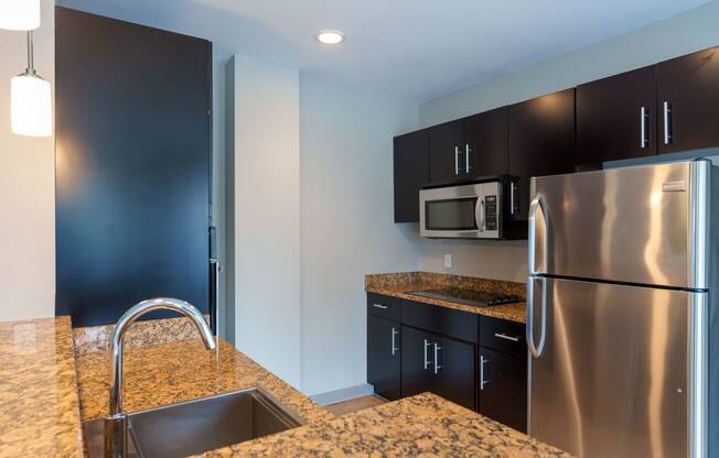 a kitchen with stainless steel appliances and granite counter tops