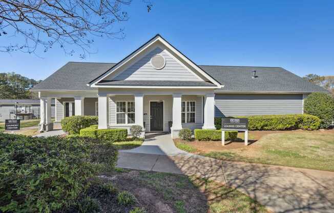 A house with a grey roof and a sign that says "LEARN CENTER".