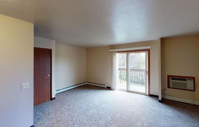 a large empty room with a sliding glass door