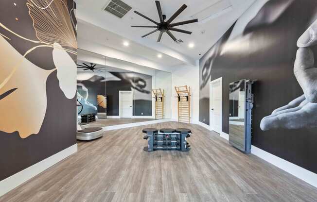 large fitness room with a large mural on the wall