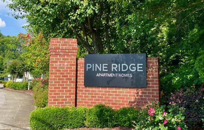 a brick wall with a sign that reads pine ridge apartments