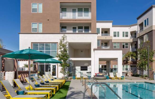 A large building with a pool in front of it.