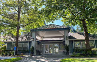 A house with a green roof and a covered patio.