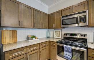 A kitchen with wooden cabinets and a stove top oven.