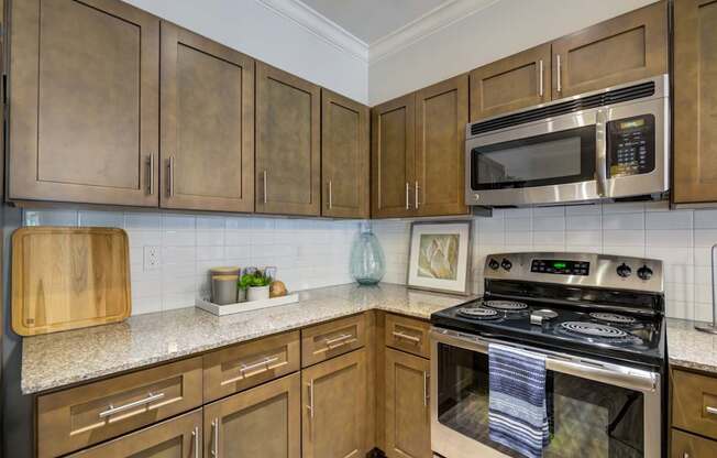 A kitchen with wooden cabinets and a stove top oven.