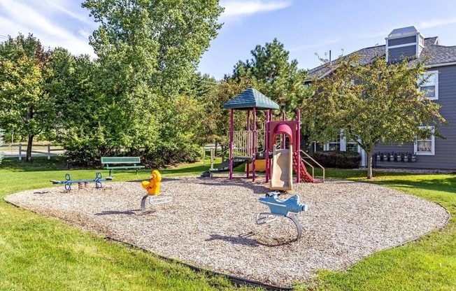 a park with a playground and a house in the background