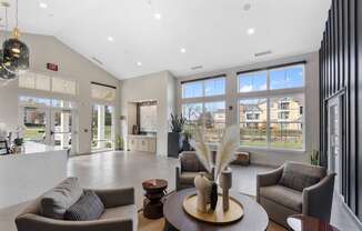 A modern living room with a large window overlooking a residential area.