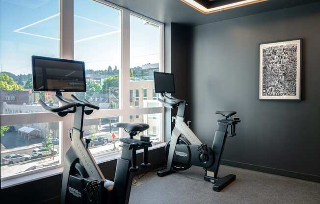 two exercise bikes in a gym next to a window at Slabtown Square Apartments, Portland ,Oregon, 97209
