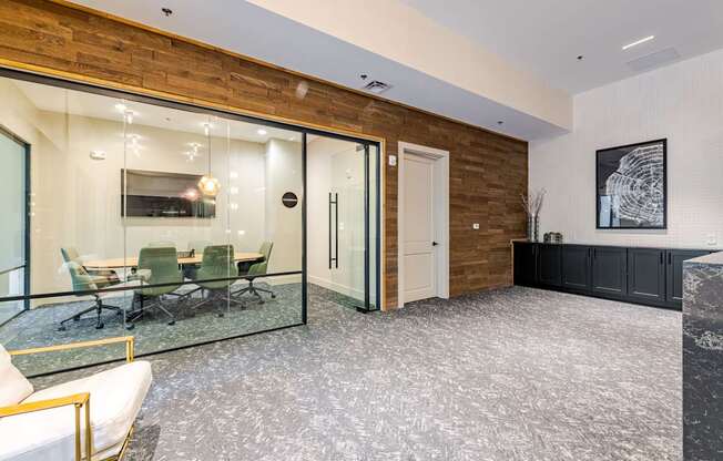 A conference room with a glass table and chairs.