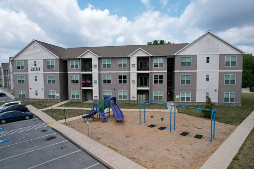 an outdoor playground at theia on the avenue apartments