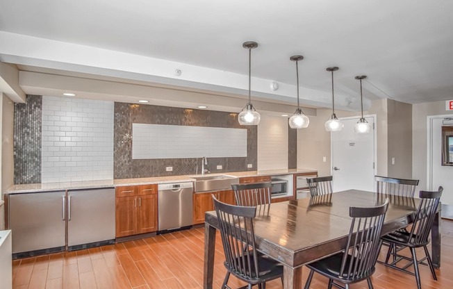 a kitchen and dining room with a table and chairs