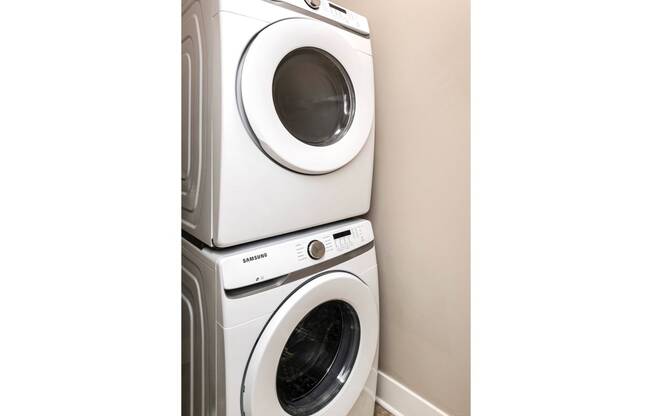 a washing machine and a dryer in a laundry room